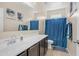 Bathroom featuring a single sink, dark cabinets, tile flooring, and a shower with blue curtain at 44232 W Palo Cedro Rd, Maricopa, AZ 85138
