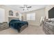 Spacious bedroom featuring carpet flooring, ceiling fan, and a large bed at 44232 W Palo Cedro Rd, Maricopa, AZ 85138