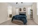 Comfortable bedroom featuring neutral walls, carpet, a ceiling fan, and an ensuite bathroom at 44232 W Palo Cedro Rd, Maricopa, AZ 85138