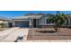 Charming single-story home featuring a well-maintained front yard, gray stucco, and a two-car garage at 44232 W Palo Cedro Rd, Maricopa, AZ 85138