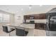 Well-equipped kitchen featuring granite countertops, dark cabinets, and stainless steel appliances at 44232 W Palo Cedro Rd, Maricopa, AZ 85138