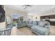 Inviting living room featuring a comfortable sofa, and sliding glass doors to backyard at 44232 W Palo Cedro Rd, Maricopa, AZ 85138