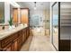 Luxurious bathroom featuring granite countertops, dual sinks, custom cabinets, tub and shower at 4684 W Tyson St, Chandler, AZ 85226