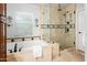 Updated bathroom with custom tiled shower, bathtub and high-end fixtures at 4684 W Tyson St, Chandler, AZ 85226