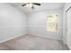 Bright bedroom featuring neutral walls, ceiling fan, window and plush carpeting at 4684 W Tyson St, Chandler, AZ 85226