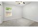 Empty bedroom featuring neutral carpet, a ceiling fan, a window, and fresh neutral paint at 4684 W Tyson St, Chandler, AZ 85226
