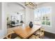 Inviting dining room featuring modern light fixture, hard wood floors and light colored furniture at 4684 W Tyson St, Chandler, AZ 85226