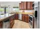 Kitchen featuring stainless steel appliances, granite countertops, and dark wood cabinetry at 4684 W Tyson St, Chandler, AZ 85226