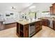 Open-concept kitchen with granite countertops, stainless steel appliances, wine fridge, and breakfast bar at 4684 W Tyson St, Chandler, AZ 85226