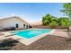 Backyard pool with diving board, desert landscaping, and privacy wall at 4684 W Tyson St, Chandler, AZ 85226