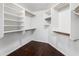 Spacious walk-in closet with custom shelving and wood flooring at 4684 W Tyson St, Chandler, AZ 85226