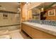 Bright bathroom featuring a double vanity, a shower, and modern lighting at 5331 E Mcdonald Dr, Paradise Valley, AZ 85253