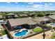 Aerial view of backyard featuring pool, patio, putting green, and desert landscaping at 5332 E Thunder Hawk Rd, Cave Creek, AZ 85331