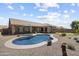 Beautiful backyard featuring a sparkling pool, lush landscaping, and a covered patio at 5332 E Thunder Hawk Rd, Cave Creek, AZ 85331