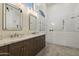 Elegant bathroom featuring double vanity sinks, and a pristine glass shower with unique fixtures at 5332 E Thunder Hawk Rd, Cave Creek, AZ 85331