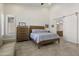 Comfortable bedroom with tile flooring and bright natural light, accompanied by matching wood dresser and bedframe at 5332 E Thunder Hawk Rd, Cave Creek, AZ 85331