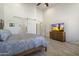 Bright bedroom with a tile floor and attached bathroom and features large TV and ceiling fan at 5332 E Thunder Hawk Rd, Cave Creek, AZ 85331