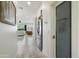 Hallway view with access to the living room, kitchen, stainless refrigerator, and a modern pantry at 5332 E Thunder Hawk Rd, Cave Creek, AZ 85331