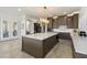 Open kitchen featuring a large island with white marble countertops, stylish cabinets, and modern stainless appliances at 5332 E Thunder Hawk Rd, Cave Creek, AZ 85331