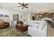 Open concept living room featuring a large sofa, stylish chairs, and seamless flow to the kitchen and dining area at 5332 E Thunder Hawk Rd, Cave Creek, AZ 85331