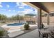 Relaxing backyard with a sparkling pool, desert landscaping, and cozy seating area at 5332 E Thunder Hawk Rd, Cave Creek, AZ 85331
