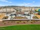 Community park with picnic tables, playground equipment, desert landscaping, and mountain views at 5464 S 246Th Ln, Buckeye, AZ 85326