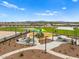 Community park featuring playground with shade structures, open green space, and picnic areas at 5464 S 246Th Ln, Buckeye, AZ 85326