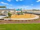 Community park playground with wood chip ground cover, swings, seating, and desert landscaping at 5464 S 246Th Ln, Buckeye, AZ 85326