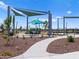 Well-maintained community park featuring walking path, mature trees, and seating areas at 5464 S 246Th Ln, Buckeye, AZ 85326