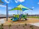 Community playground with covered slides and climbing equipment surrounded by desert landscaping at 5464 S 246Th Ln, Buckeye, AZ 85326
