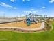 Community playground featuring blue slides, play equipment, shade, and wood chip ground cover at 5464 S 246Th Ln, Buckeye, AZ 85326