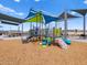 Colorful playground with climbing wall, slide, and sun shades in a well-maintained community park setting at 5464 S 246Th Ln, Buckeye, AZ 85326