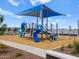 Community playground featuring slides, climbing area, with sun shades on a sunny day at 5464 S 246Th Ln, Buckeye, AZ 85326