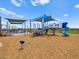 Community playground with sun shades, slides, and climbing areas on a sunny day at 5464 S 246Th Ln, Buckeye, AZ 85326