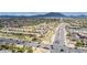 Conveniently located near roadways, an aerial view shows the surrounding neighborhood and scenic mountain backdrop at 6648 S Lyon Dr, Gilbert, AZ 85298
