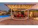 Backyard featuring a pergola with seating area, beautiful landscaping and inviting pool at 6648 S Lyon Dr, Gilbert, AZ 85298