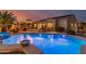 Beautiful backyard with swimming pool, a raised spa, and a covered seating area at 6648 S Lyon Dr, Gilbert, AZ 85298