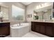 Bright bathroom features a soaking tub, granite countertops, and tile flooring at 6648 S Lyon Dr, Gilbert, AZ 85298