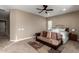 Relaxing bedroom with ceiling fan, carpeted floors, couch, and window with natural light at 6648 S Lyon Dr, Gilbert, AZ 85298