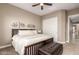 Cozy bedroom boasts a ceiling fan, decorative wall art, and plush bedding at 6648 S Lyon Dr, Gilbert, AZ 85298
