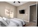 Tranquil bedroom with carpet, a mounted TV, and direct access to the hallway at 6648 S Lyon Dr, Gilbert, AZ 85298