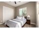 Neutral bedroom features carpet, ceiling fan, and a pair of double-door closet at 6648 S Lyon Dr, Gilbert, AZ 85298