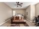 Cozy bedroom with ceiling fan, carpeted floors, couch, desk, and good natural light at 6648 S Lyon Dr, Gilbert, AZ 85298