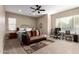 Comfortable bedroom with ceiling fan, couch, desk, and good natural light from the window at 6648 S Lyon Dr, Gilbert, AZ 85298
