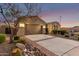 Charming home featuring a well-manicured front yard and a spacious driveway leading to a two-car garage at 6648 S Lyon Dr, Gilbert, AZ 85298