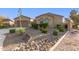 Attractive home exterior with a two-car garage and low-maintenance desert landscaping, adding to its charm at 6648 S Lyon Dr, Gilbert, AZ 85298