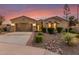 Charming single-story home featuring a well-manicured yard, desert landscaping, and a welcoming entrance with a gated courtyard at 6648 S Lyon Dr, Gilbert, AZ 85298