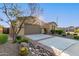 Well-maintained home exterior featuring a two-car garage, desert landscaping, and excellent curb appeal at 6648 S Lyon Dr, Gilbert, AZ 85298