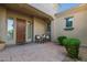 Inviting front porch with a cozy seating area, perfect for relaxing and enjoying the neighborhood views at 6648 S Lyon Dr, Gilbert, AZ 85298