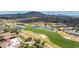 Overhead view capturing the beautiful golf course and water feature set within a stunning mountain backdrop at 6648 S Lyon Dr, Gilbert, AZ 85298
